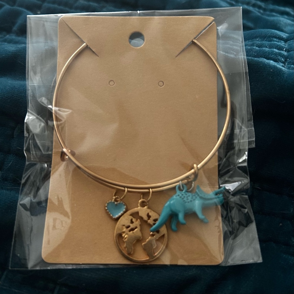 Gold Tone Bracelet with Turquoise Dinosaur and Globe Charms